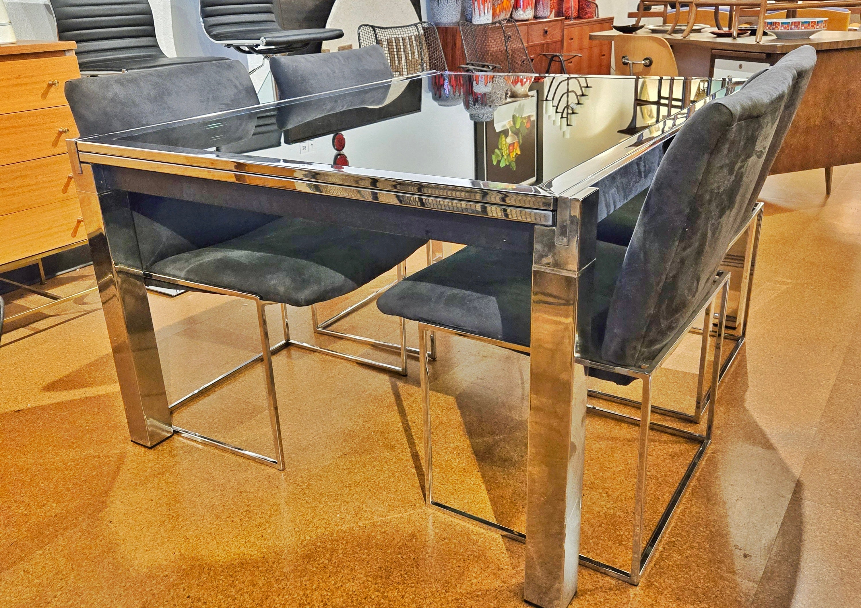 GLASS-TOP CHROMED STEEL DRAW-LEAF TABLE IN THE STYLE OF MILO BAUGHMAN