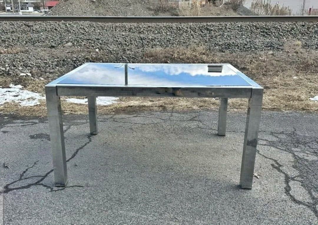 GLASS-TOP CHROMED STEEL DRAW-LEAF TABLE IN THE STYLE OF MILO BAUGHMAN