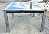 GLASS-TOP CHROMED STEEL DRAW-LEAF TABLE IN THE STYLE OF MILO BAUGHMAN