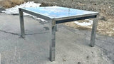 GLASS-TOP CHROMED STEEL DRAW-LEAF TABLE IN THE STYLE OF MILO BAUGHMAN