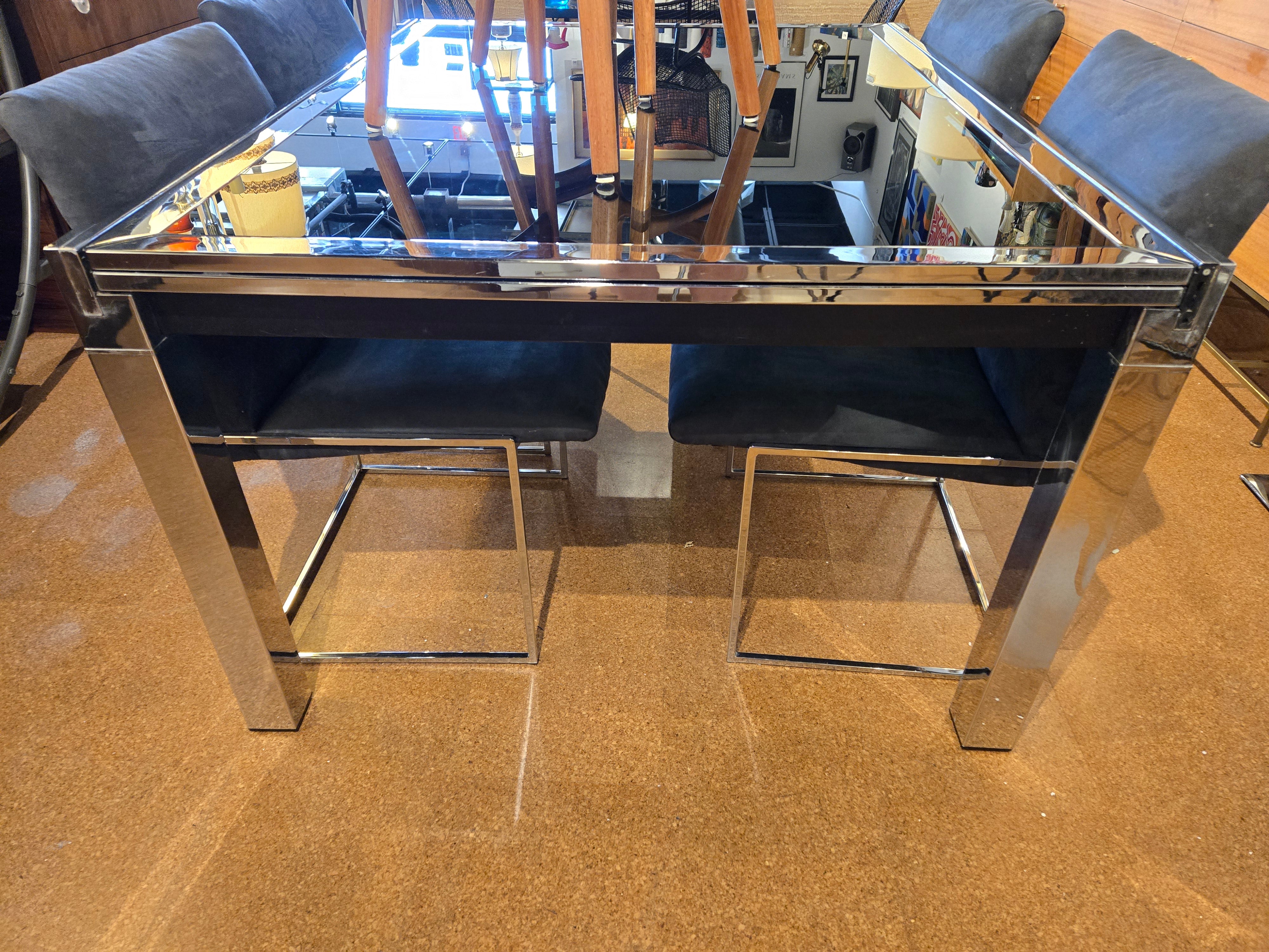 GLASS-TOP CHROMED STEEL DRAW-LEAF TABLE IN THE STYLE OF MILO BAUGHMAN