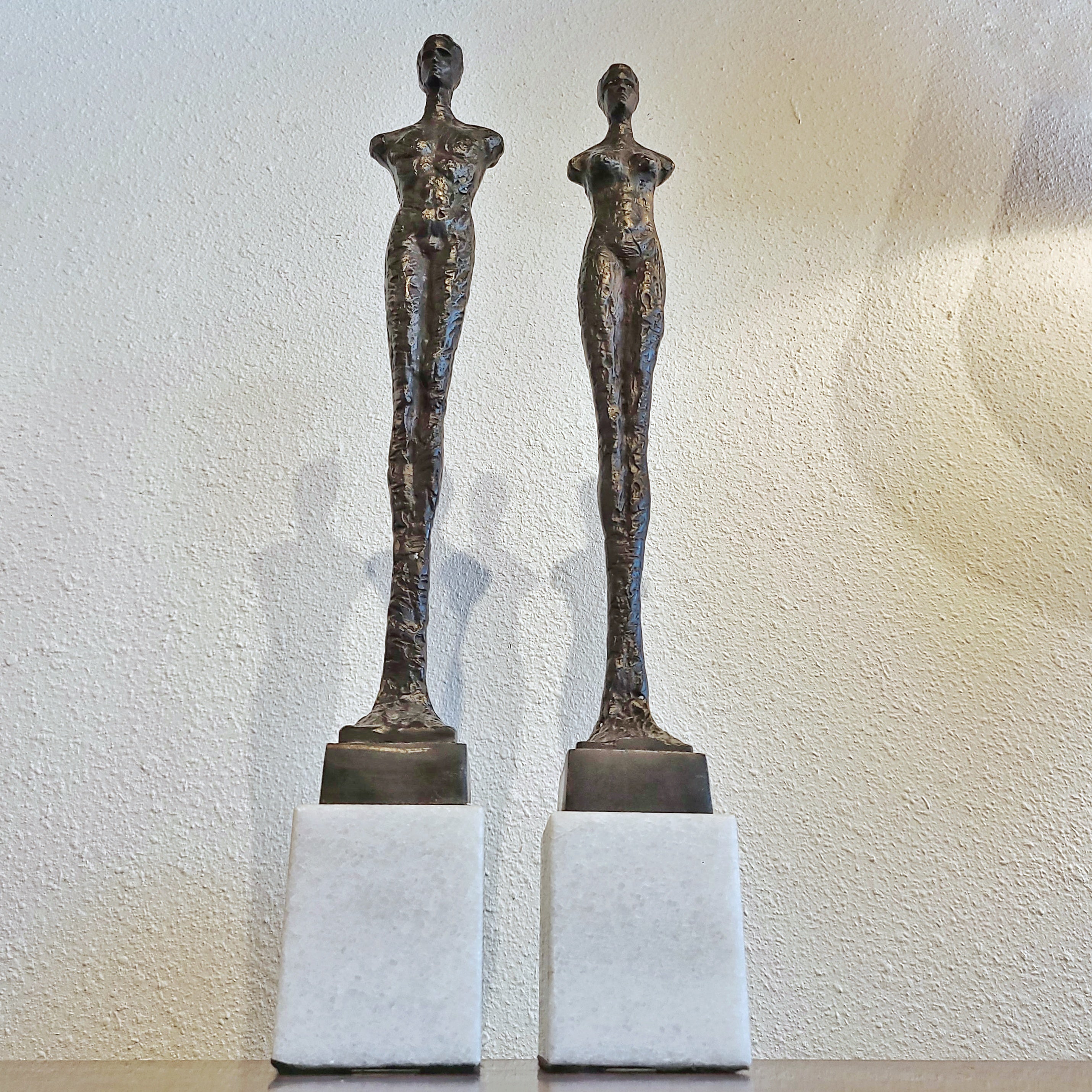 SLENDER ARMLESS COUPLE IN CAST BRONZE ON QUARTZ BASES