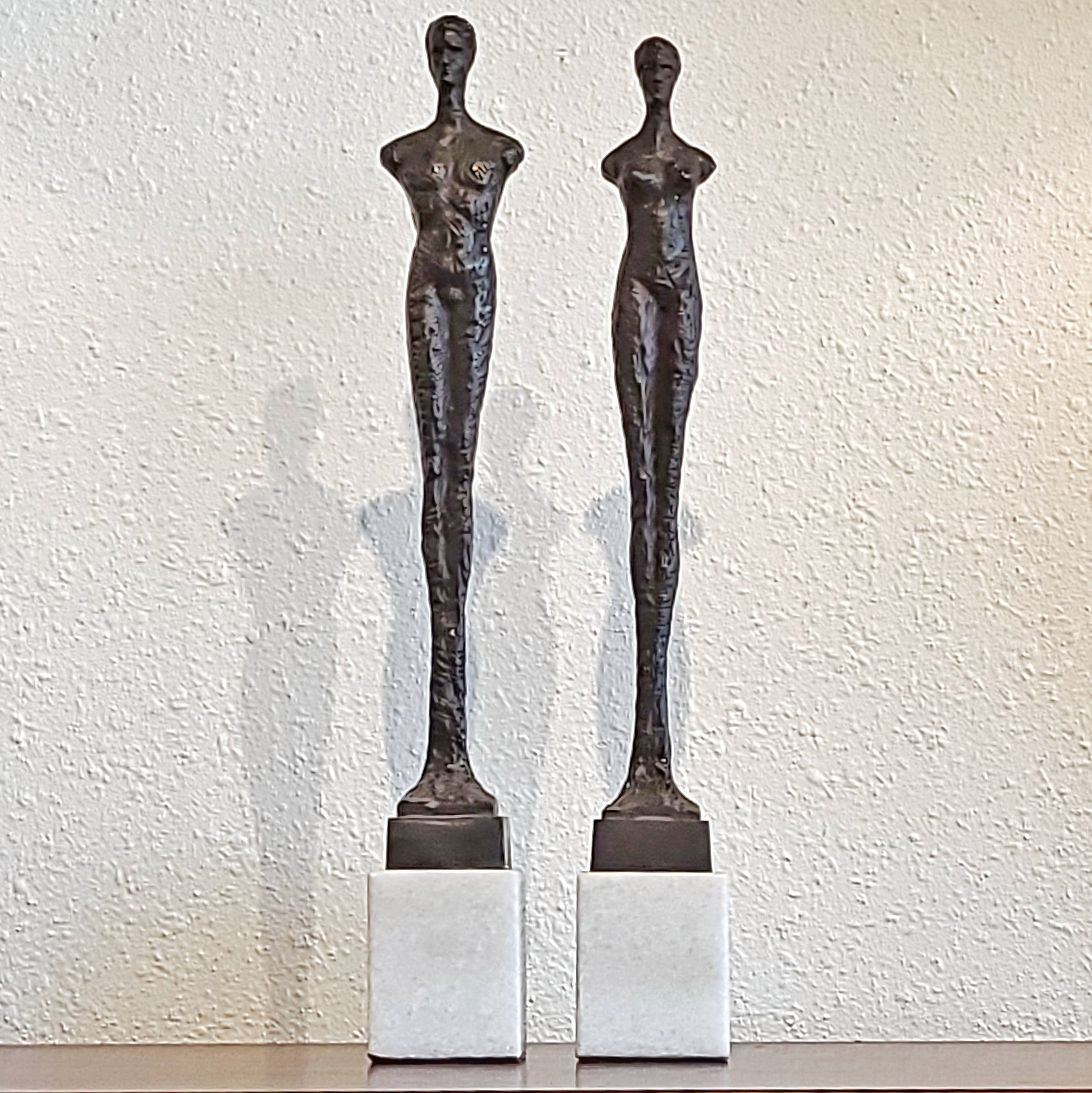 SLENDER ARMLESS COUPLE IN CAST BRONZE ON QUARTZ BASES