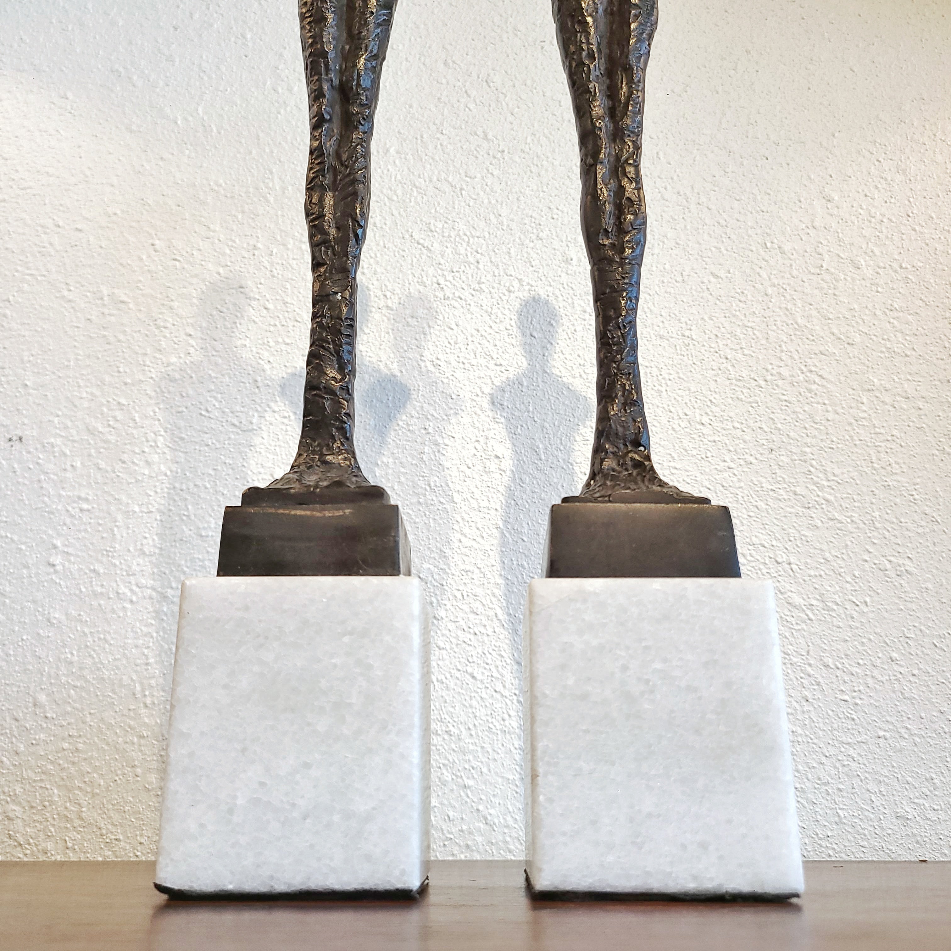 SLENDER ARMLESS COUPLE IN CAST BRONZE ON QUARTZ BASES